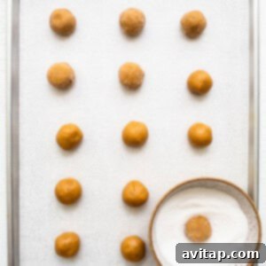 A tray of peanut butter balls on a white surface.