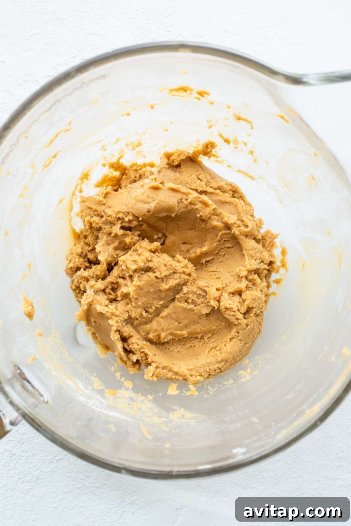 Creamy Peanut Butter Dough: The Heart of Your Cookies Smooth peanut butter cookie dough in a mixing bowl, ready for the next step in baking.