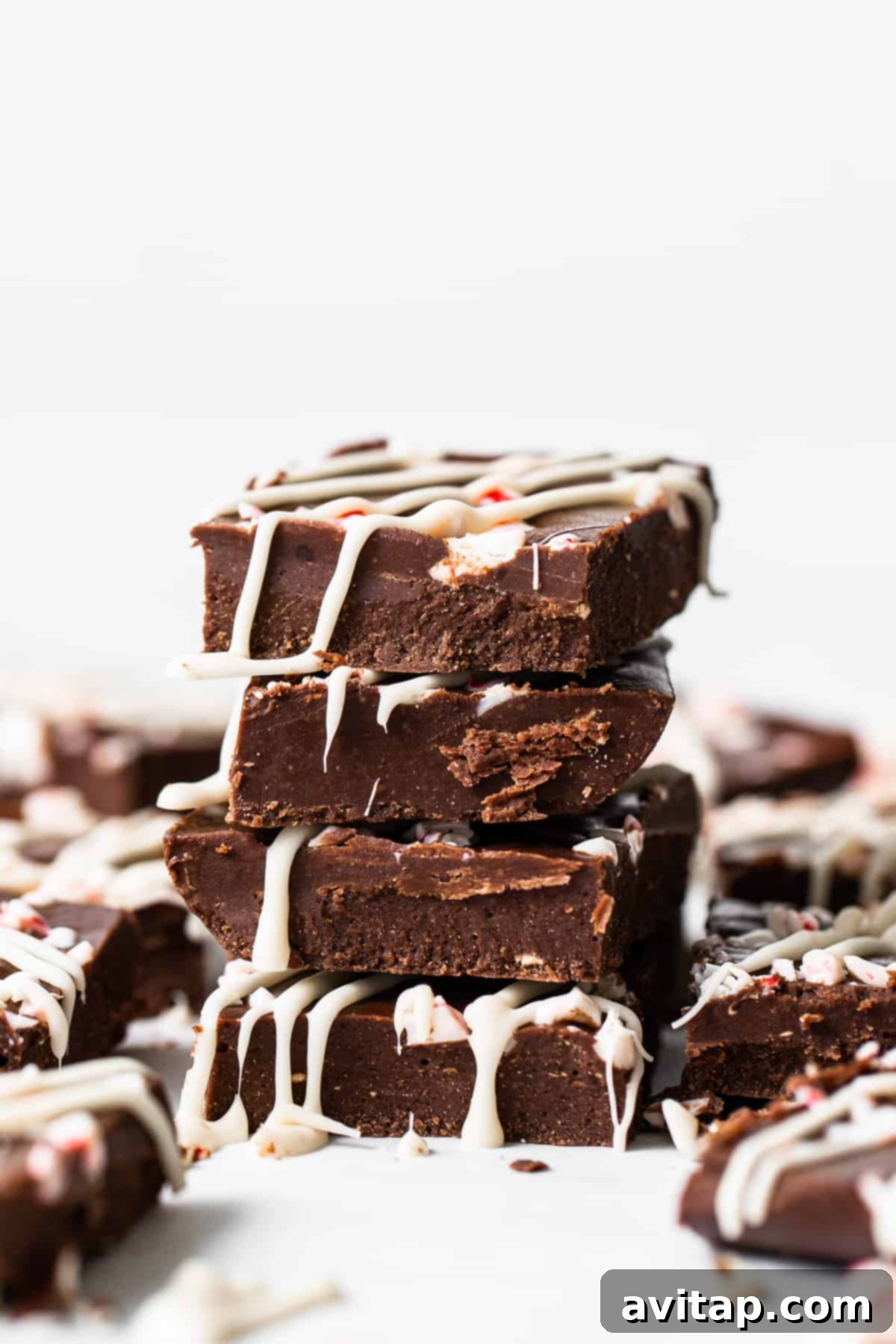 No-Bake Peppermint Fudge 2 Stacked peppermint freezer fudge pieces, ready to be enjoyed.
