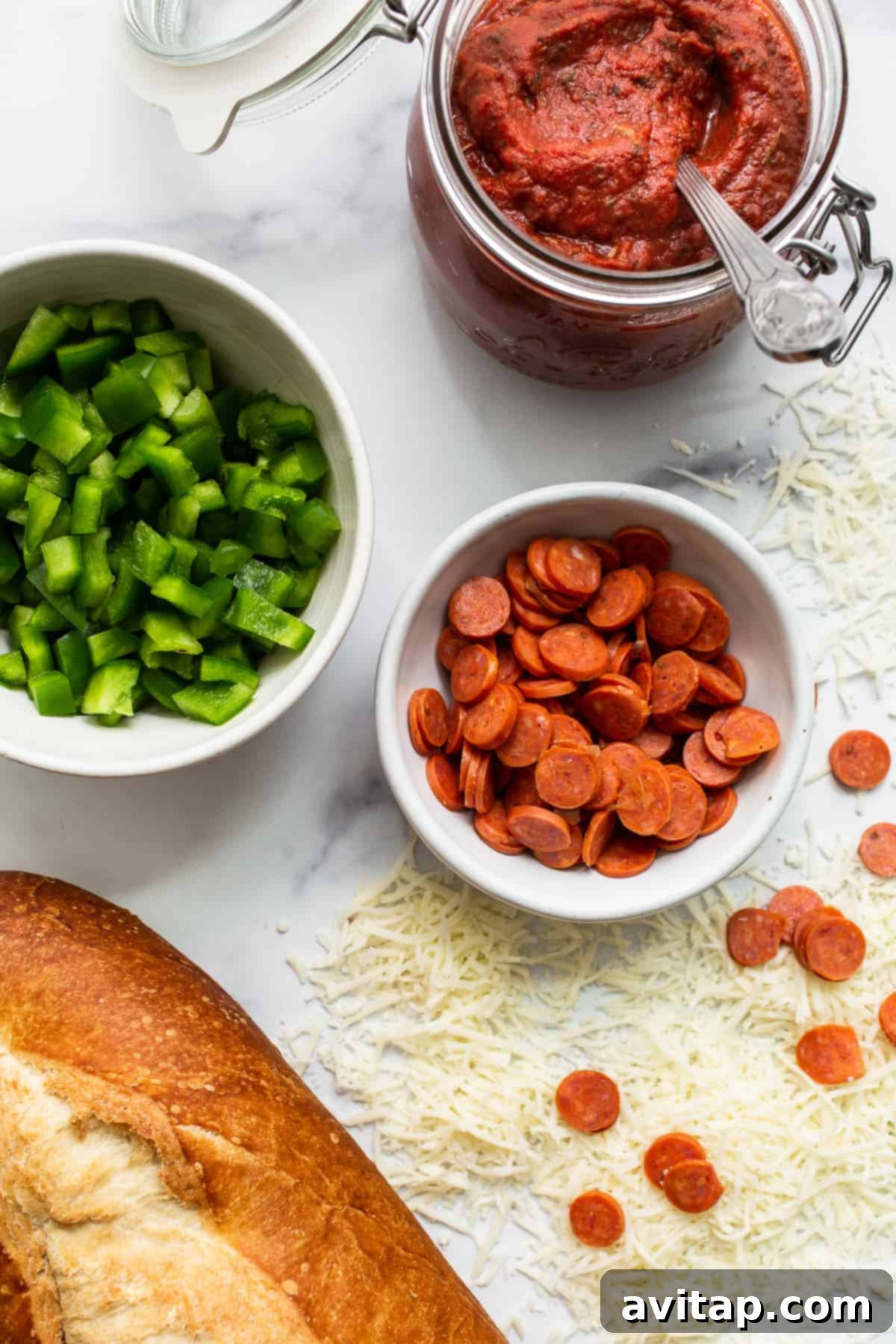 Fresh Ingredients for French Bread Pizza Ingredients for making French bread pizza laid out on a surface.