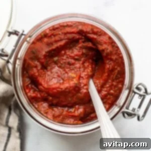Crusty Loaf Pizzas 2 Homemade pizza sauce in a bowl with a wooden spoon.