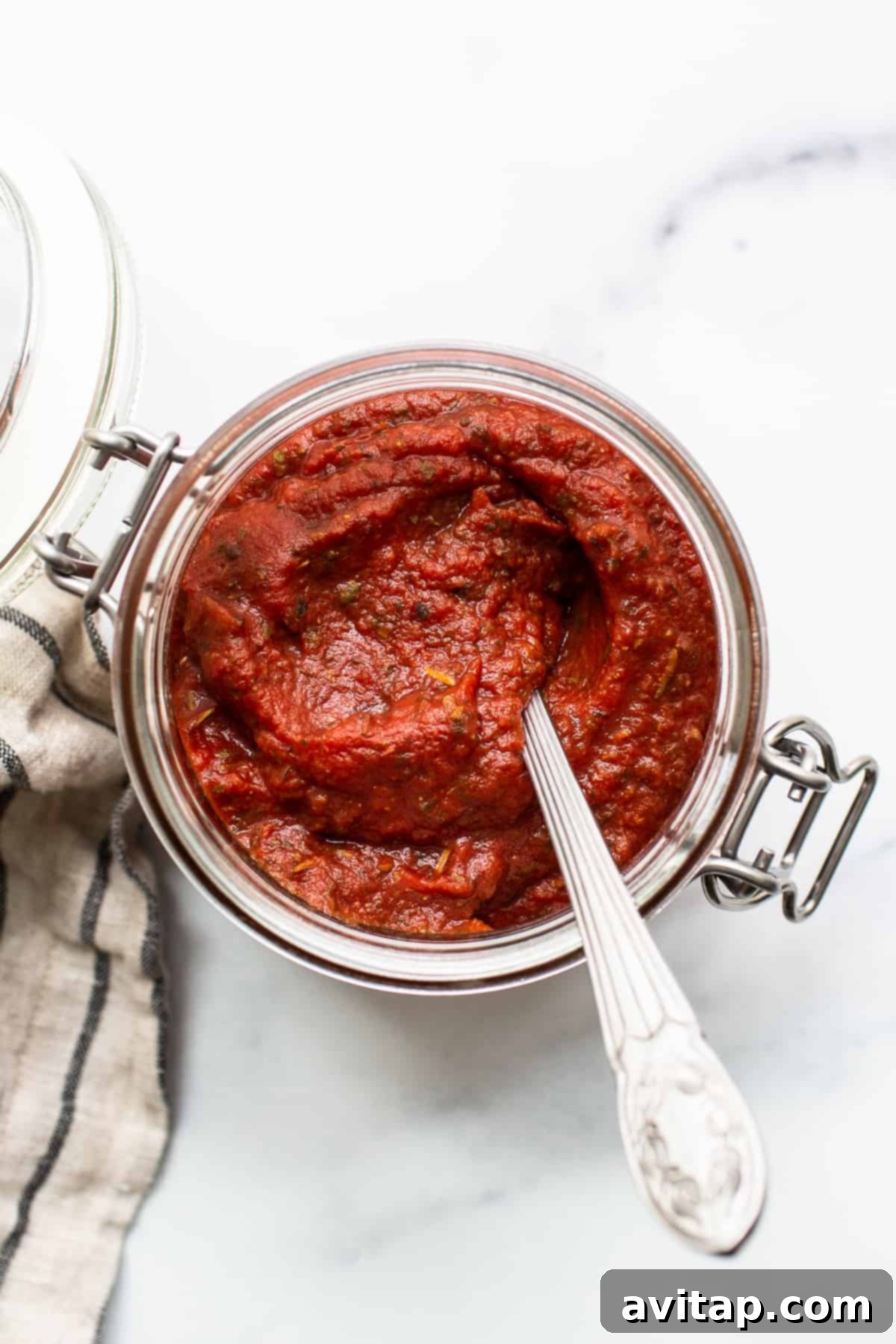 A beautiful jar filled with vibrant homemade pizza sauce, ready to use or store.