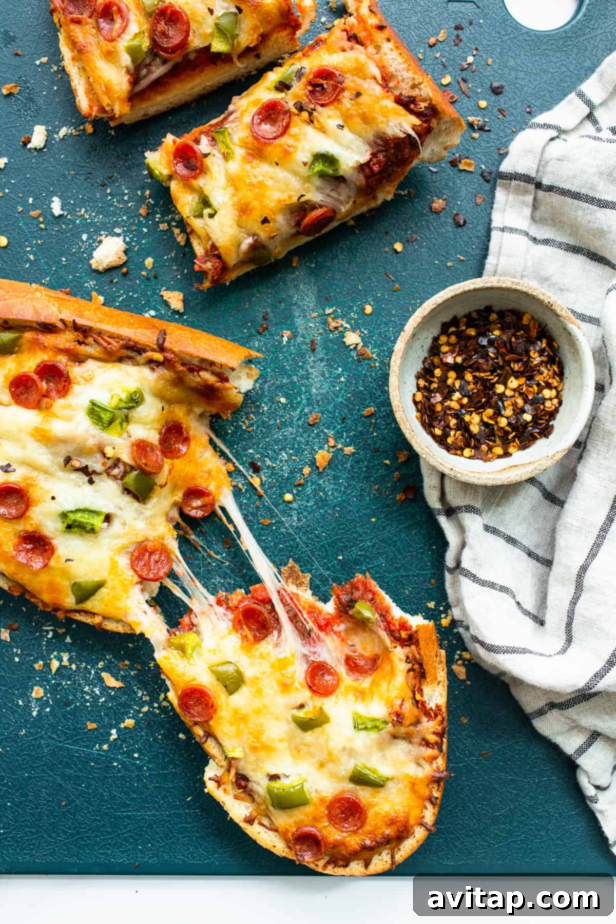 Delicious slices of homemade pizza with vibrant red sauce on a wooden cutting board, ready to be served.