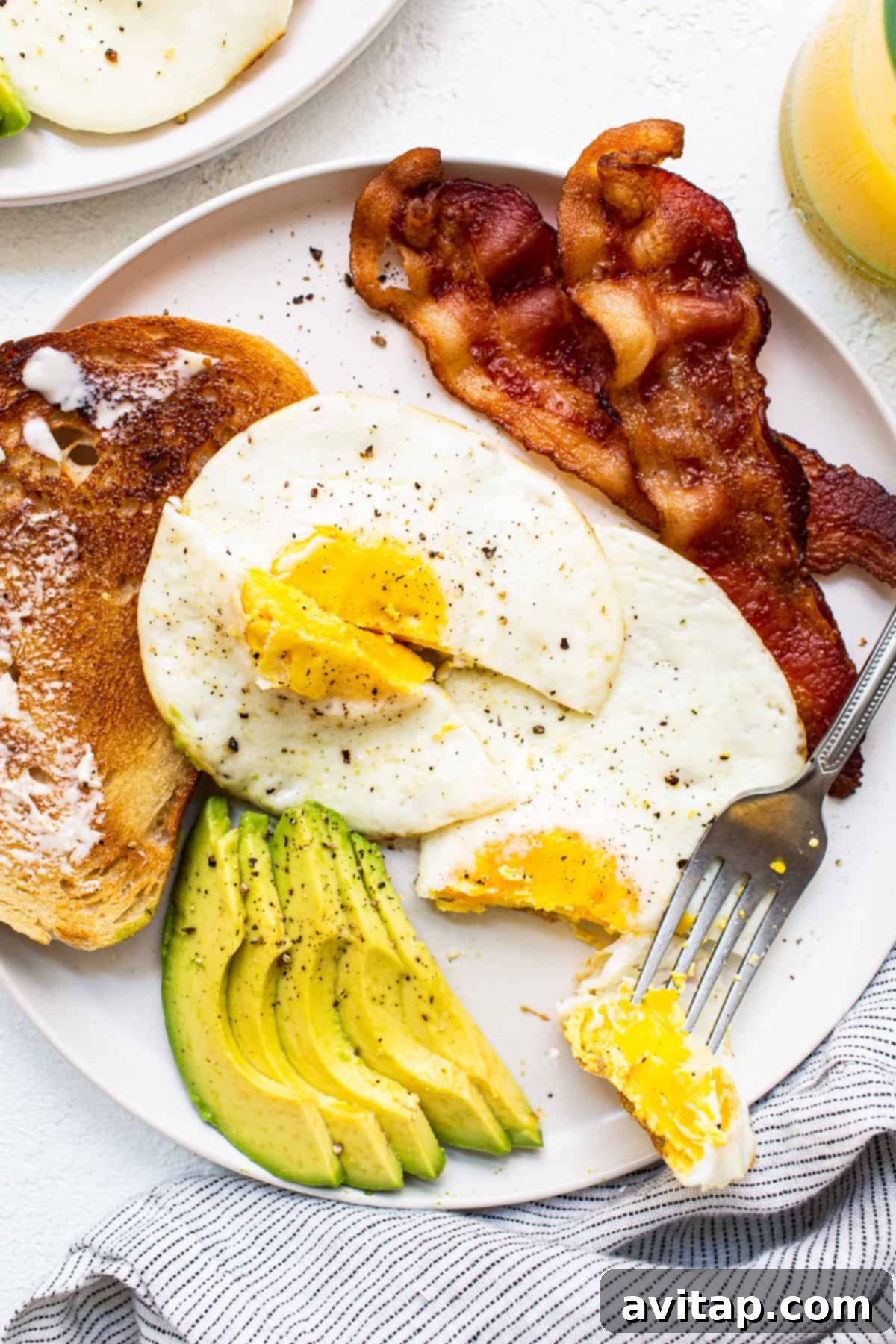 A perfectly cooked over hard egg on a white plate, ready to be served for breakfast.