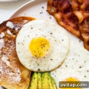 A perfectly cooked over hard egg on a white plate, ready to be served.