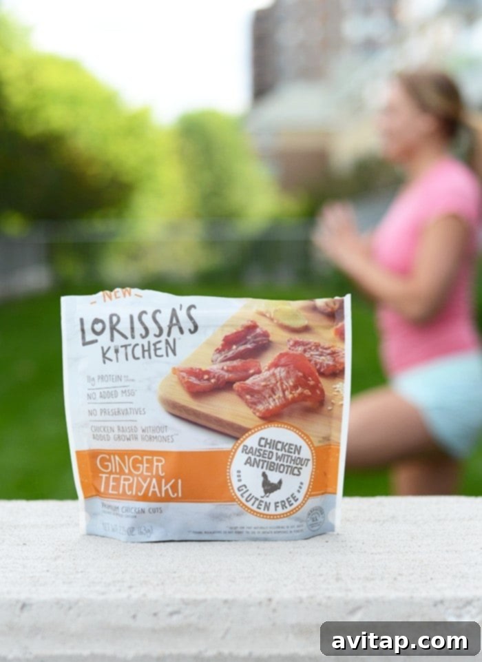 A woman enjoys a healthy protein snack from Lorissa's Kitchen amidst a lush green summer landscape, highlighting active outdoor living.