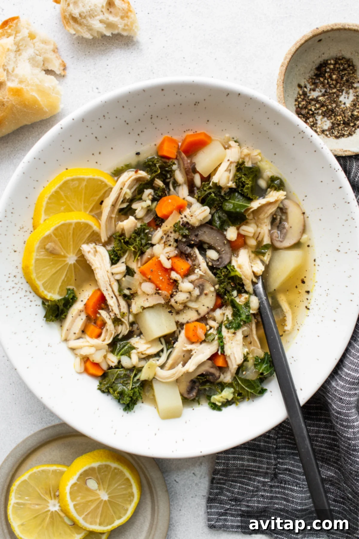 The Perfect Chicken Soup 2 A steaming bowl of Ultimate Chicken Soup garnished with fresh herbs, ready to be enjoyed.