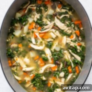 Fresh kale leaves added to the simmering chicken soup.