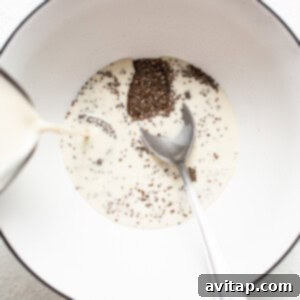 A spoon is pouring chia seeds into a bowl.