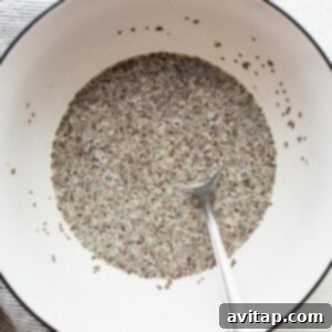 Chia seeds in a bowl with a spoon, demonstrating the thickened pudding.