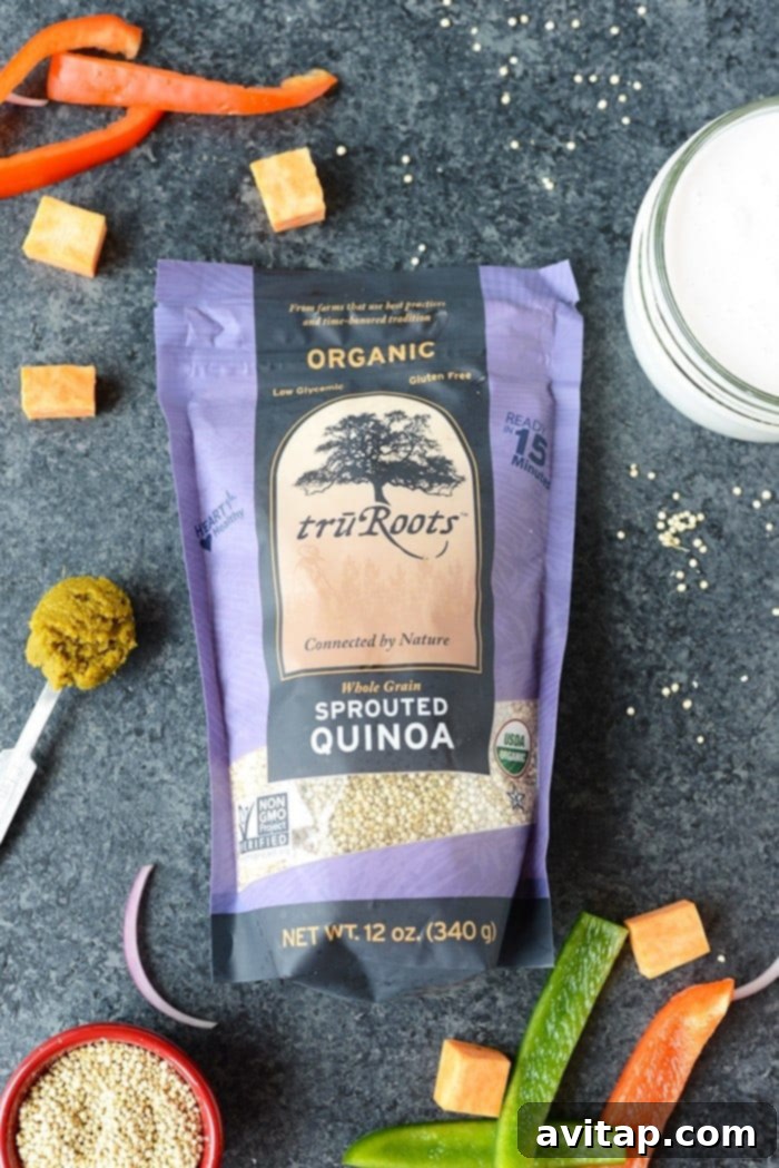 A generous serving of Sweet Potato Green Curry Quinoa Casserole in a bowl, topped with fresh herbs and a squeeze of lime, ready to be enjoyed as a hearty meal.