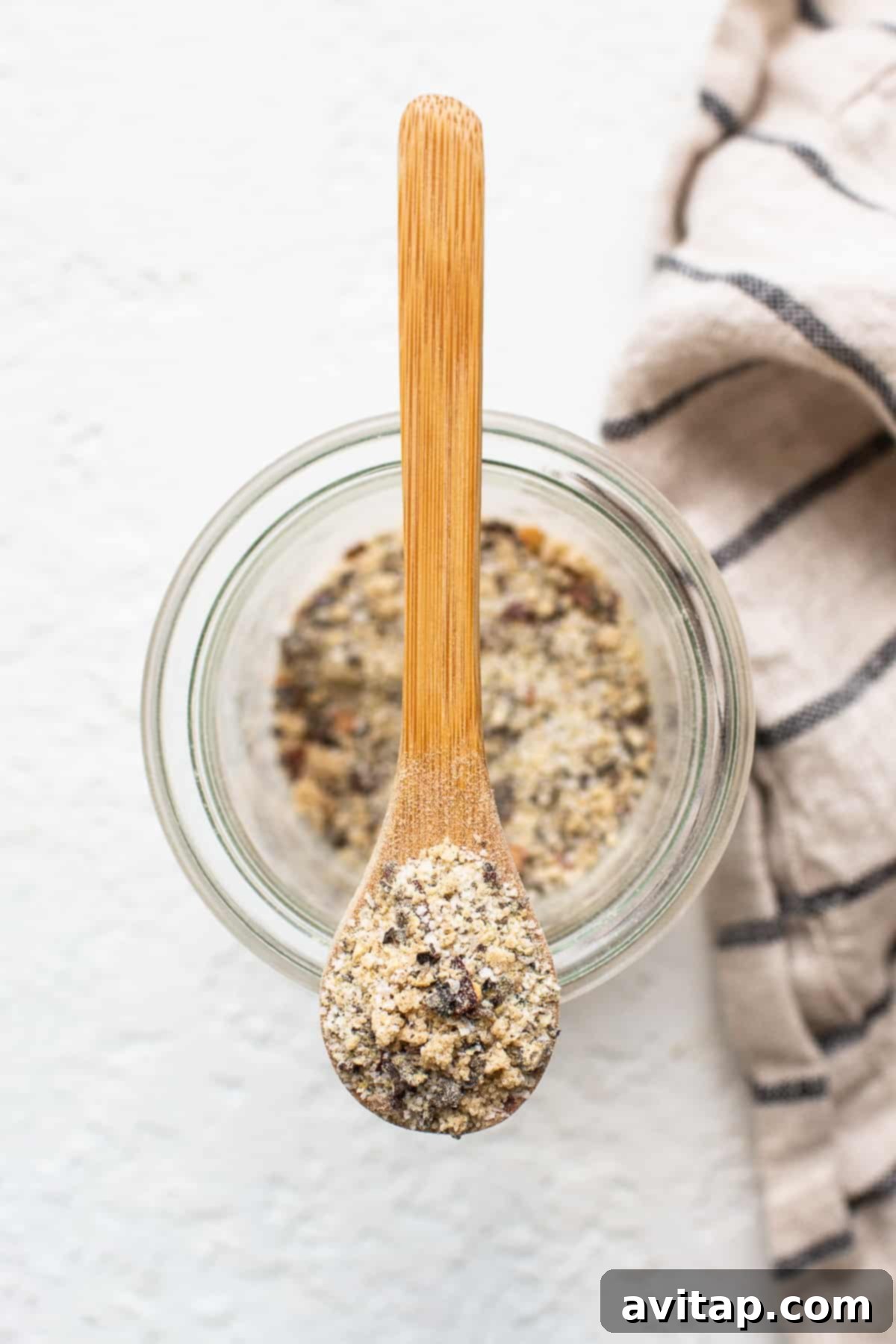 A closer look at the perfectly blended homemade steak seasoning on a spoon. A spoon full of homemade steak seasoning, showing its texture and blend of spices.
