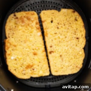 Two slices of bread in an air fryer.