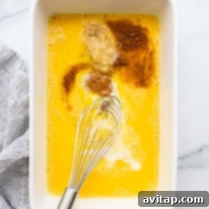 A white dish with a whisk in it.
