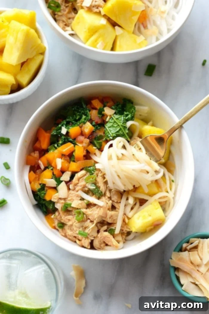 Island Chicken Noodle Feast 4 A close-up of a delicious Hawaiian Chicken Noodle Bowl, showing the vibrant shredded chicken, stir-fried vegetables, and noodles.