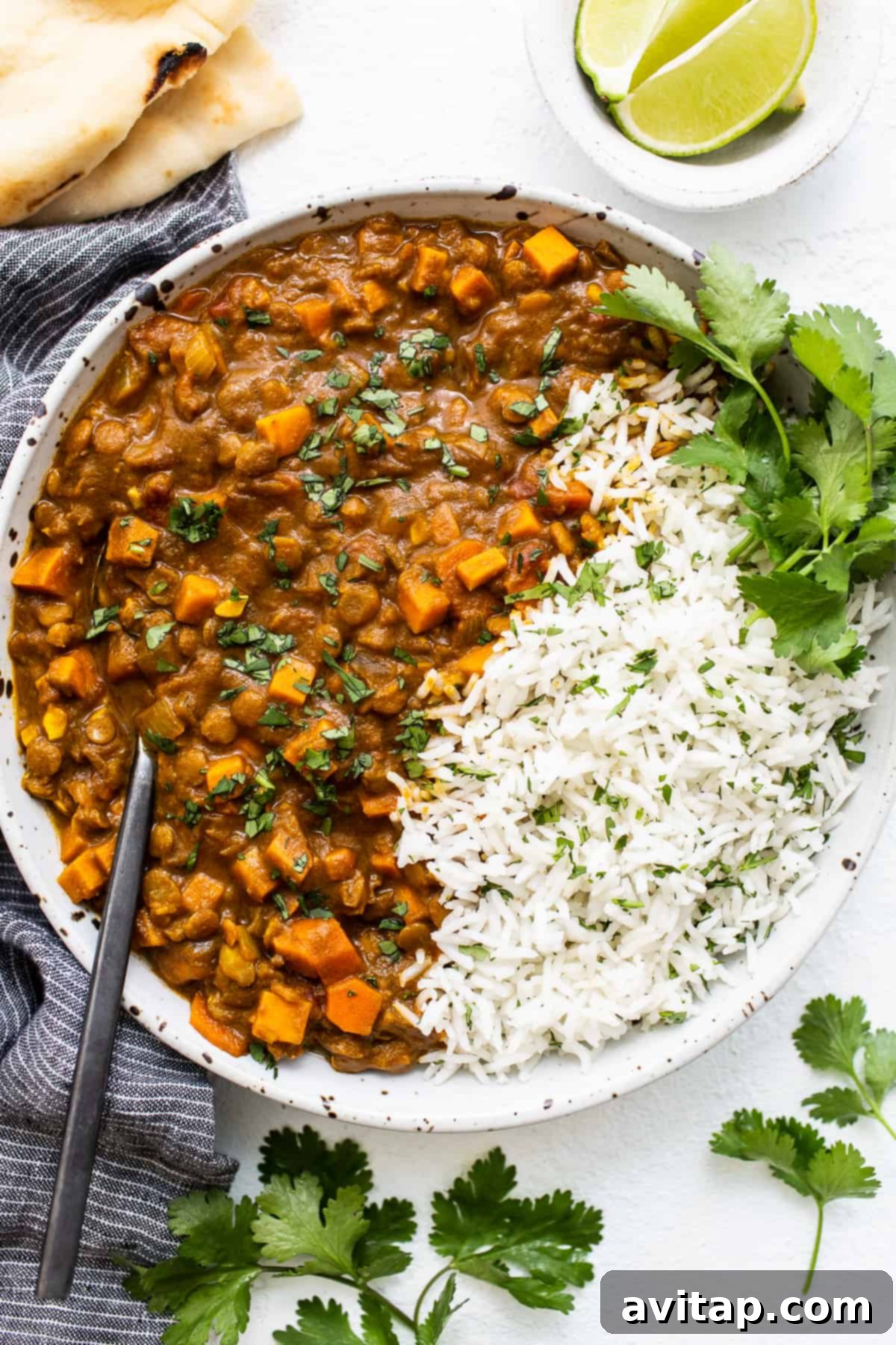 A vibrant bowl of vegetarian lentil curry, ready to be enjoyed. Vegetarian lentil curry in a bowl.