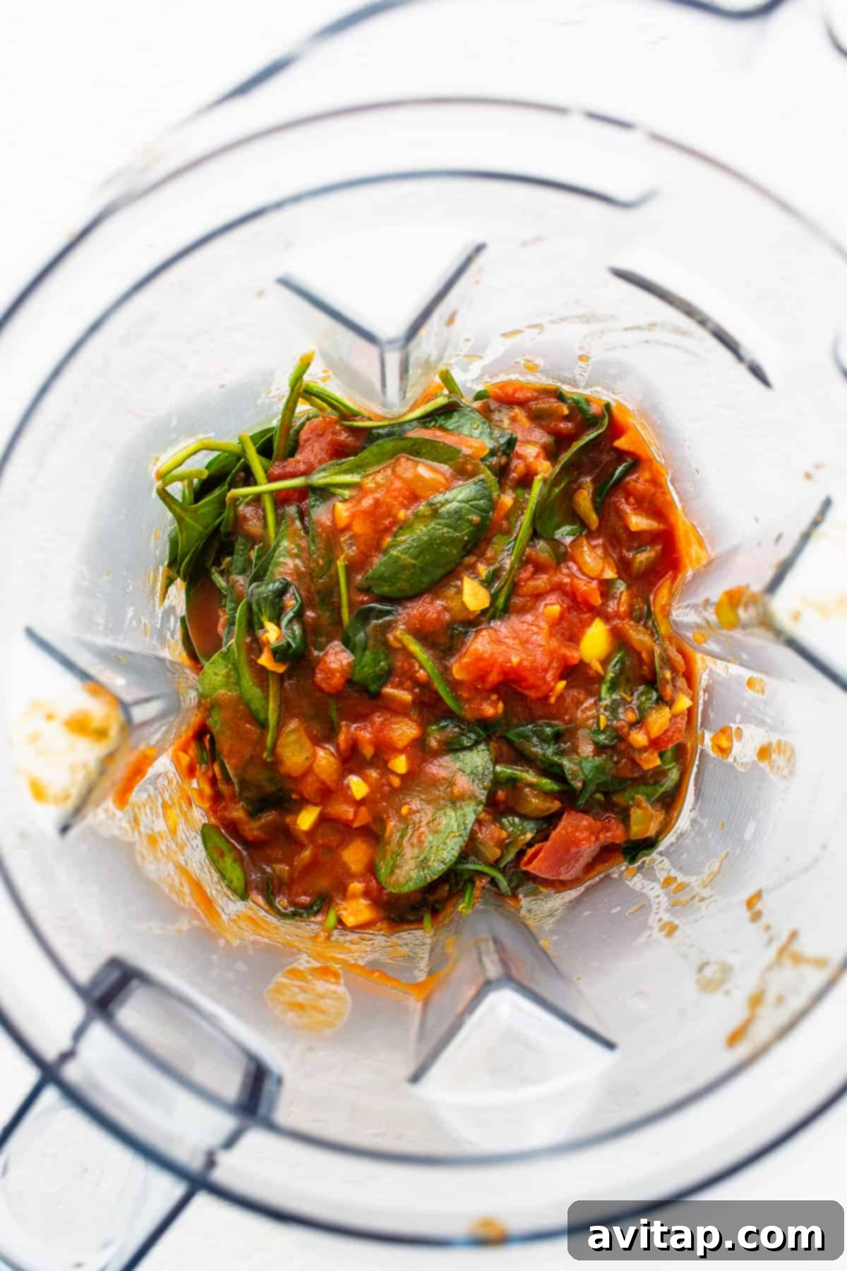Blended spinach and tomato sauce. Spinach and tomato sauce in a blender.