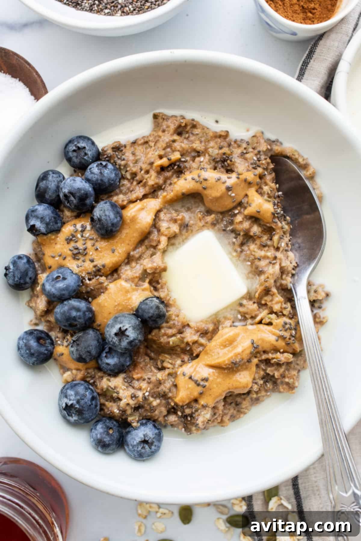 A bowl of creamy porridge topped with fresh blueberries, ready to be enjoyed.