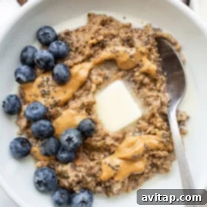 A bowl of porridge topped with fruit and nut butter.