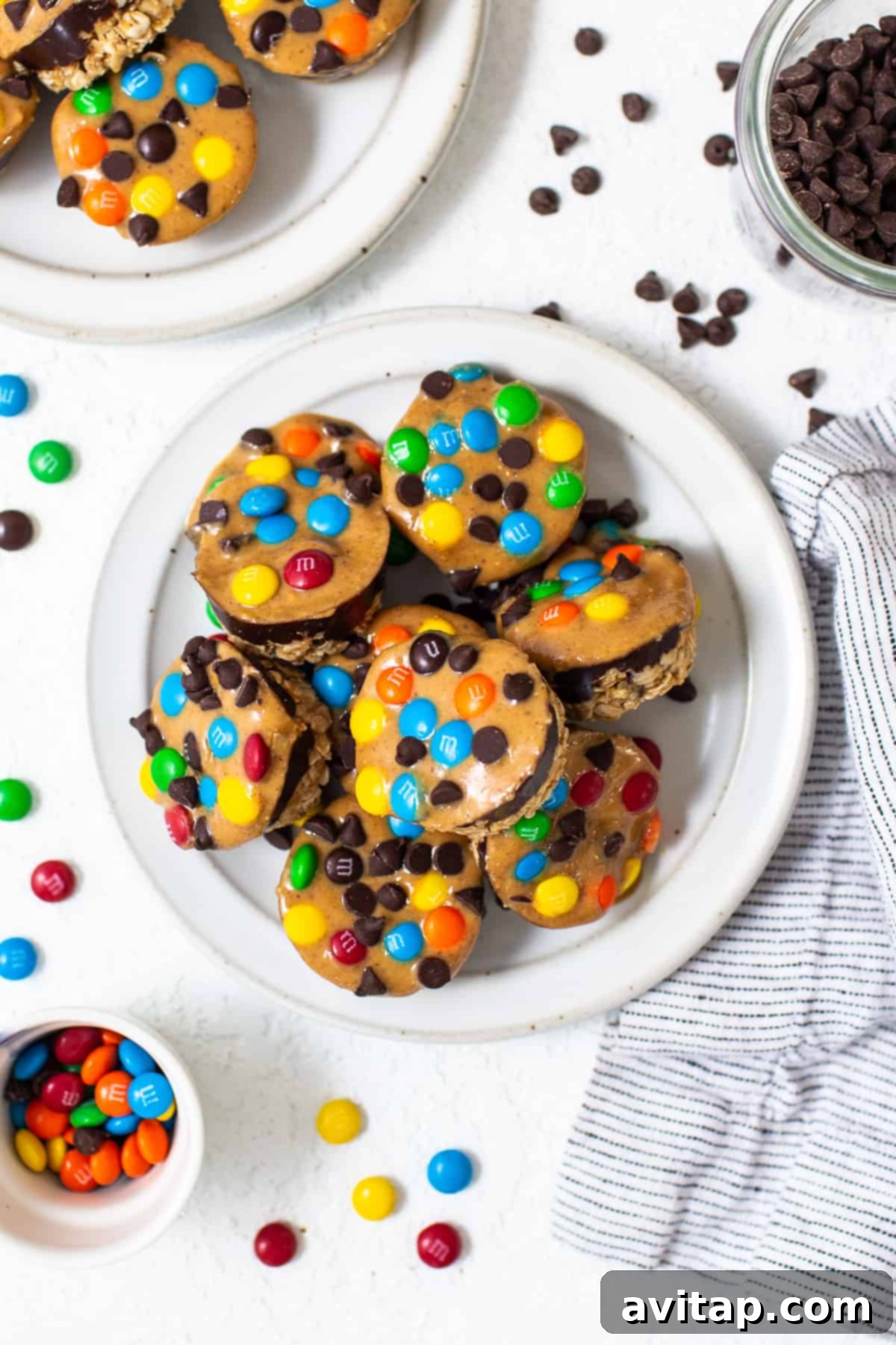A vibrant pile of Monster Cookie Oat Cups arranged on a white plate, ready to be enjoyed.