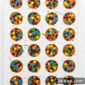 A tray of monster cookie oat cups topped with M&M's and chocolate chips.