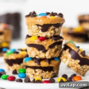 Monster cookie oat cups stacked on a plate, ready to be stored or enjoyed.