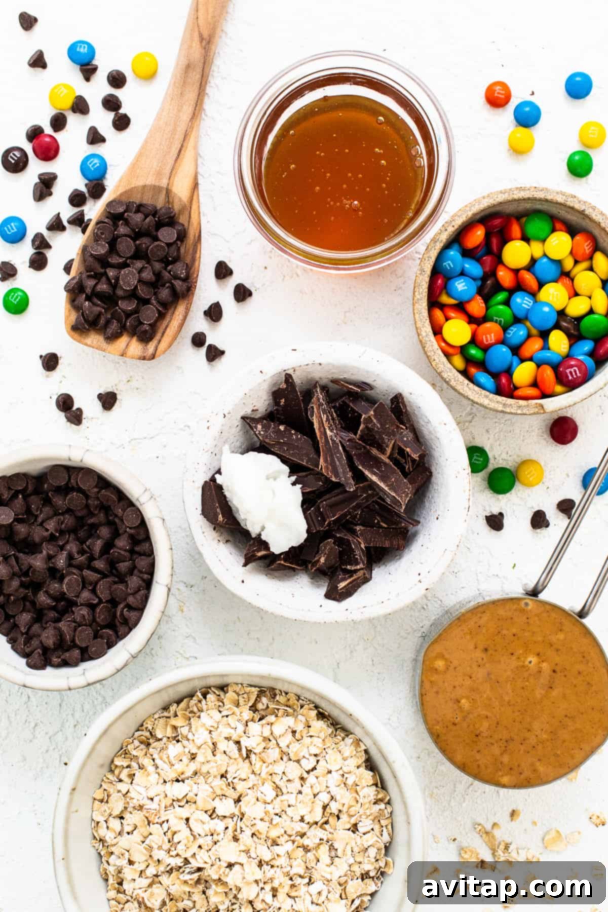 Bowls of ingredients for monster cookie oat cups, neatly arranged on a counter.