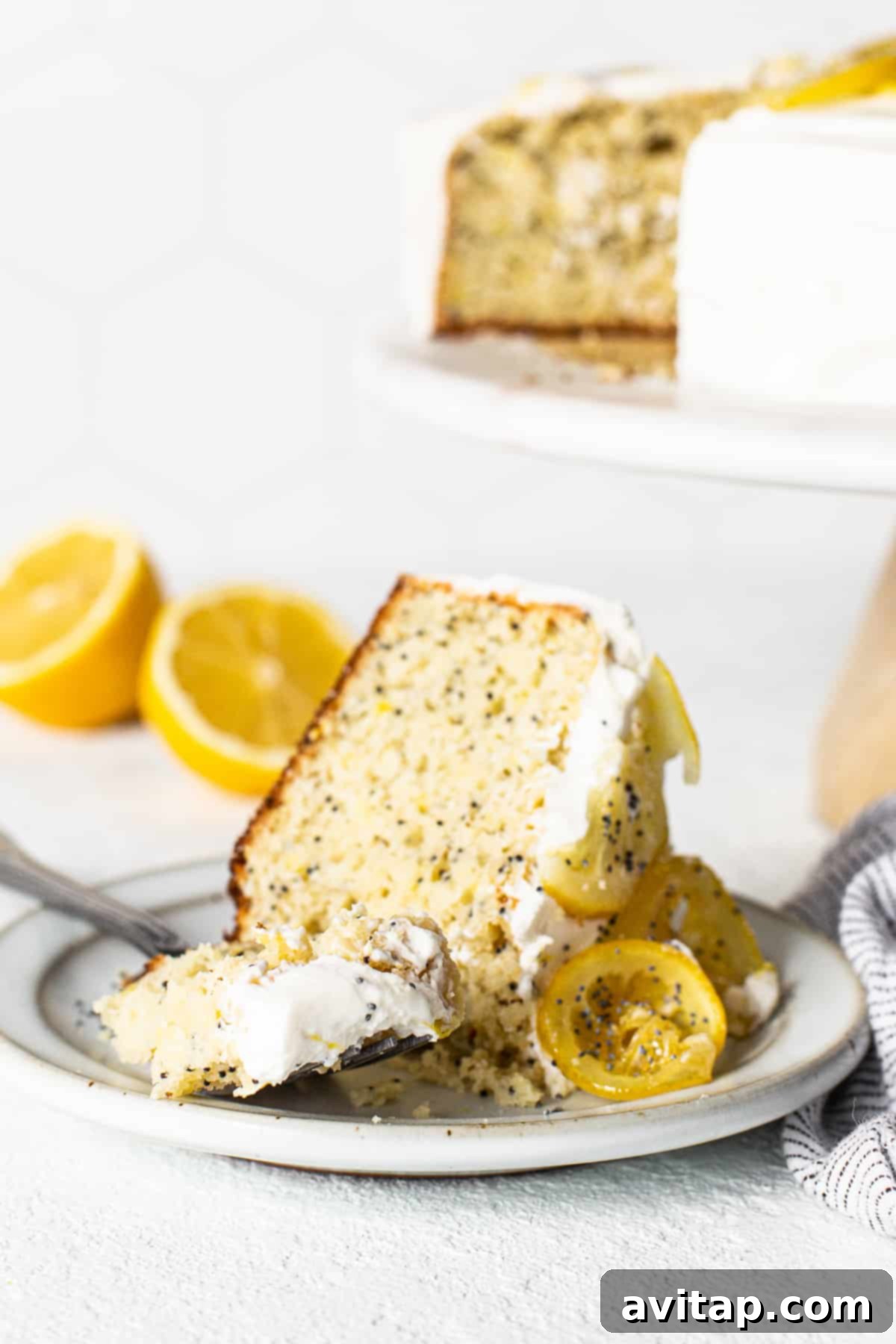 Close-up of a delightful lemon poppy seed cake slice. Slice of lemon poppy seed cake on a fork, showing its fluffy texture and frosting.