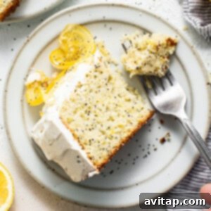 Zesty Lemon Poppy Seed Bliss 2 Slice of lemon poppy seed cake on a plate, showcasing its beautiful layers.