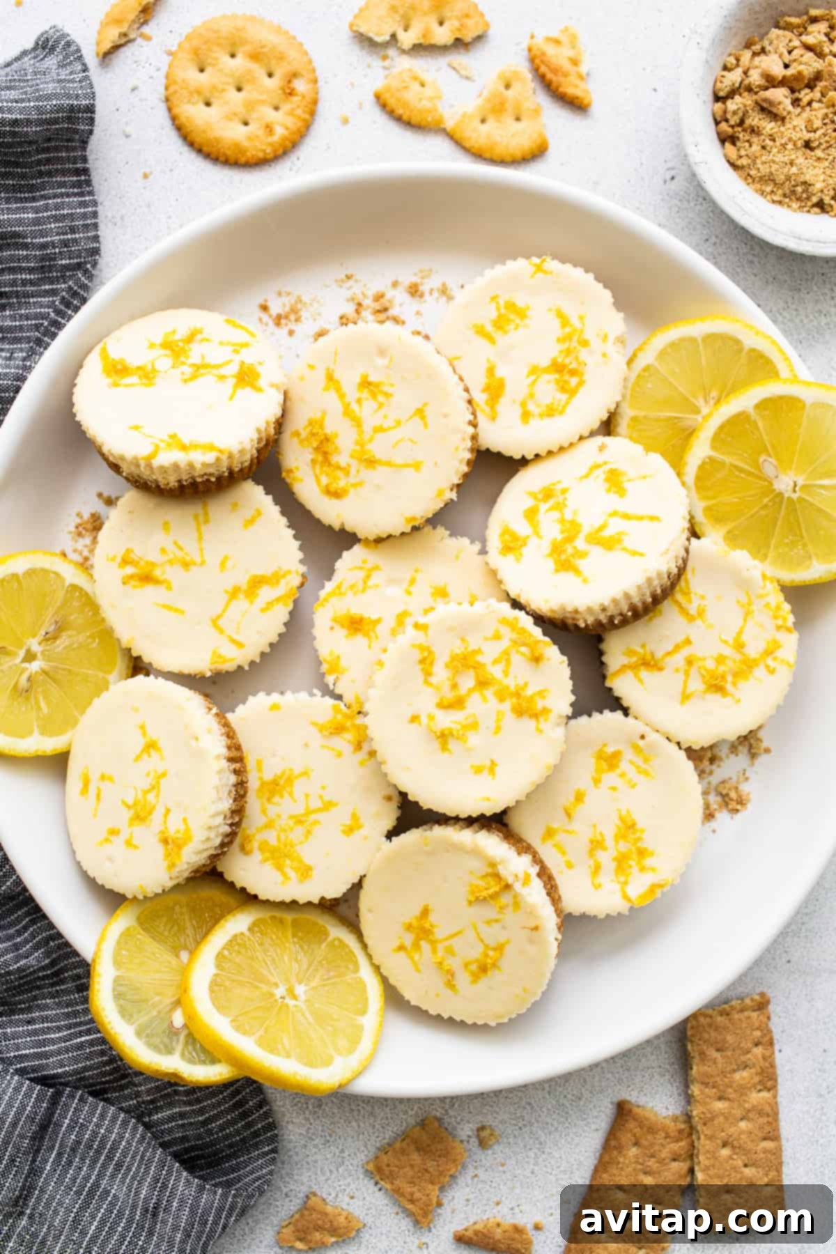 This mini cheesecake recipe is made with a sweet and salty crust, cream cheese, honey, vanilla, and lemon zest making them the perfect Spring dessert. mini cheesecakes on plate.