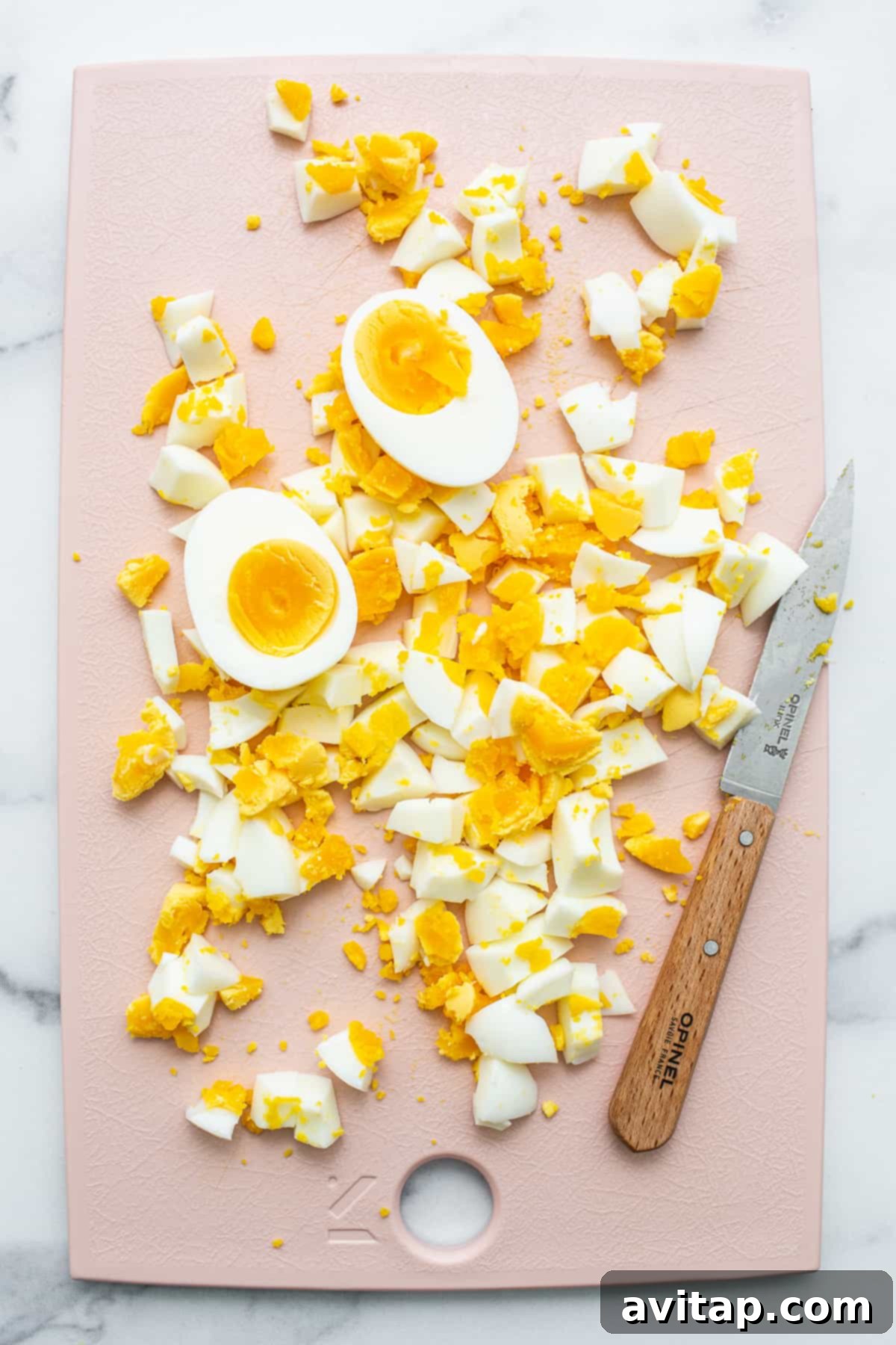 chopped eggs on cutting board.
