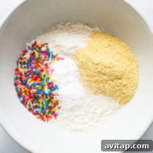 Dry ingredients including flour, masa harina, baking powder, and salt in a bowl.
