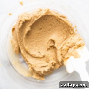 Cookie dough batter in a mixing bowl after combining wet and dry ingredients.
