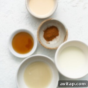 Four small bowls containing different ingredients for the tres leches sauce, ready to be combined.
