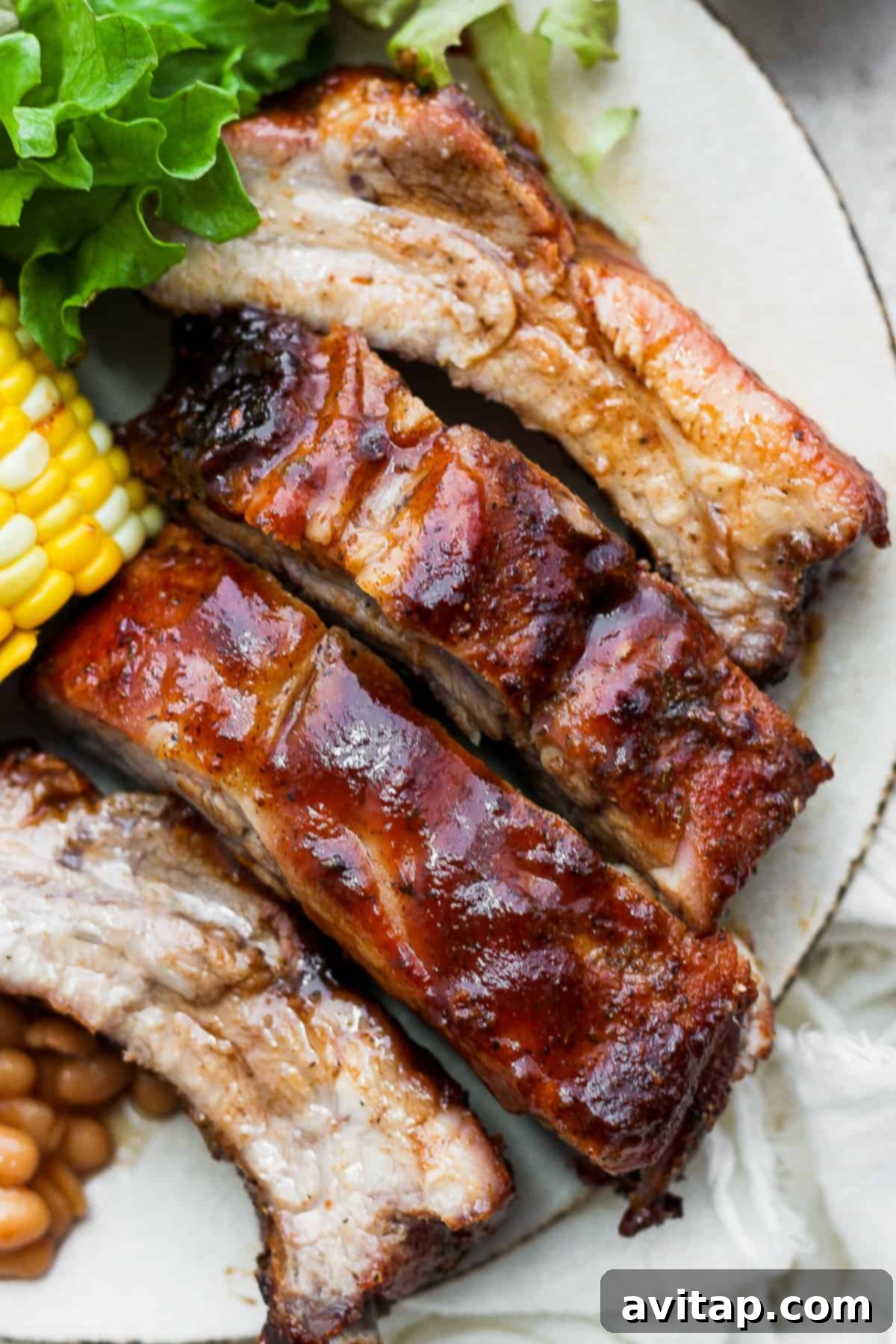 Dry rubbed ribs on a plate.