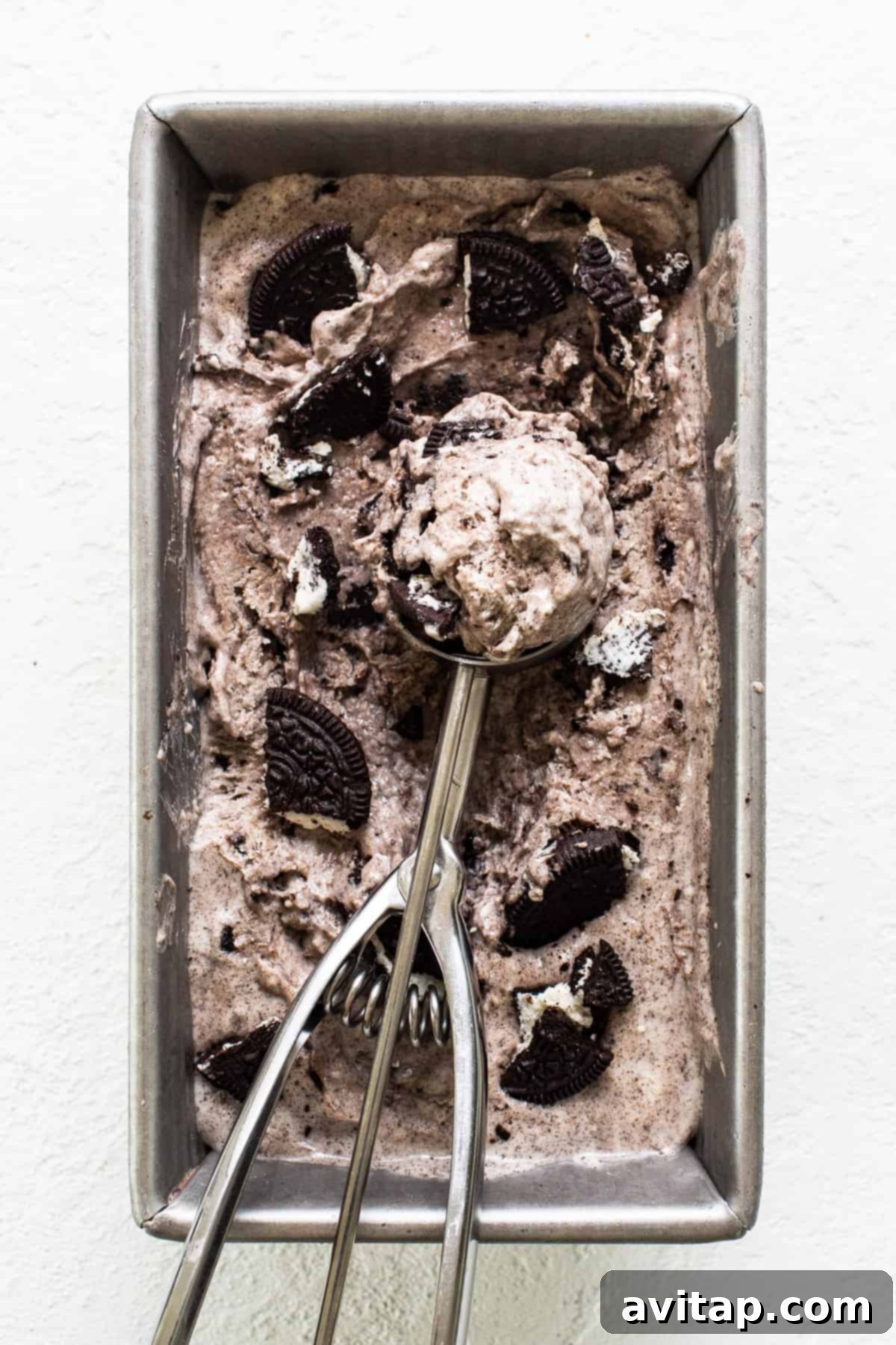 The finished, frozen cookies and cream cottage cheese ice cream in a loaf pan, ready to be scooped and served.