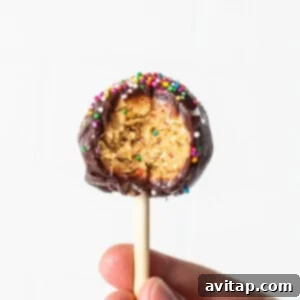 A protein cake pop with a bite taken out of it.