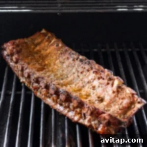 a piece of meat is cooking on a grill.