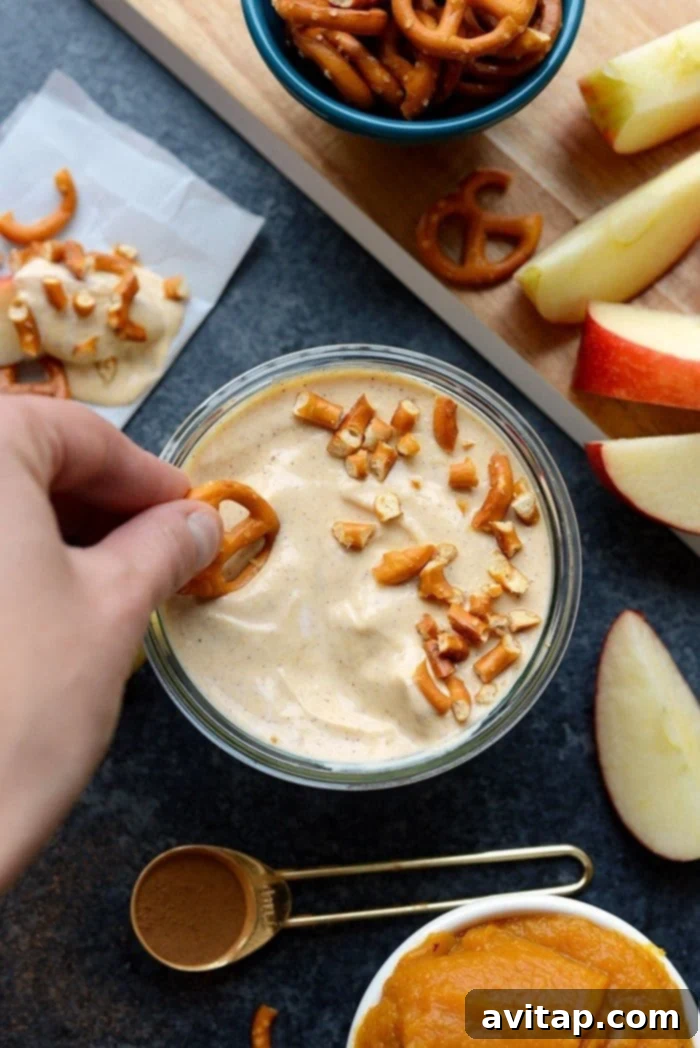 Spiced Pumpkin Yogurt Delight 4 Three small bowls of pumpkin yogurt dip, ready for serving with various dippers.