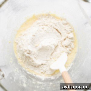 Golden Peach Upside Down Cake 10 A bowl of flour with a wooden spoon in it, representing the dry ingredients.