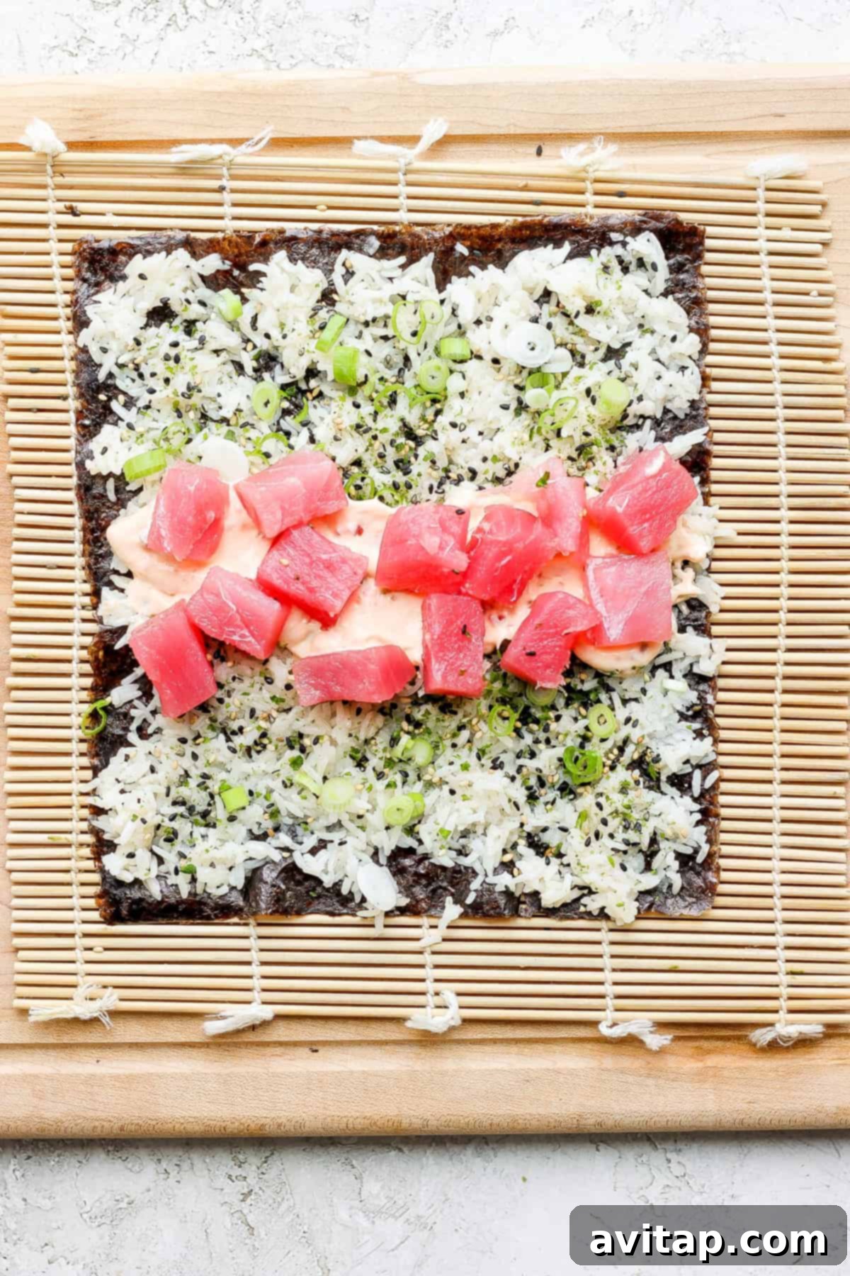 A perfectly rolled sushi piece on a bamboo mat, showcasing the tight form and colorful filling.