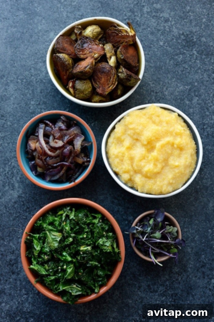 Close-up of a vegetarian meal prep bowl featuring roasted Brussels sprouts, creamy polenta, and kale