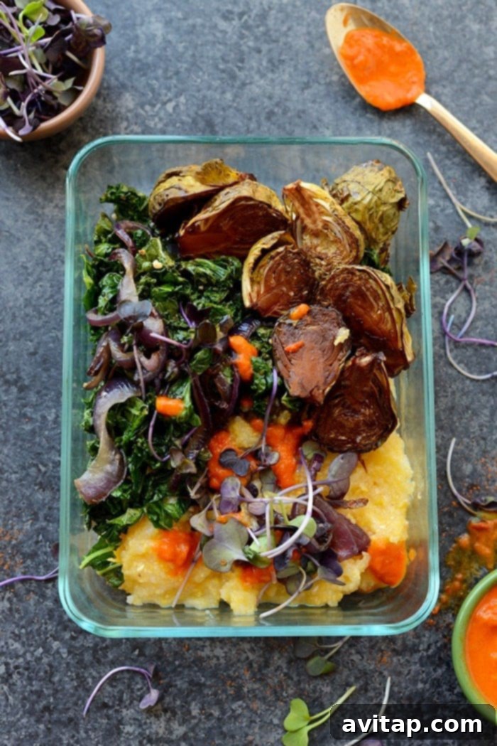 Vegetarian meal prep bowl with roasted Brussels sprouts, creamy polenta, and fresh toppings
