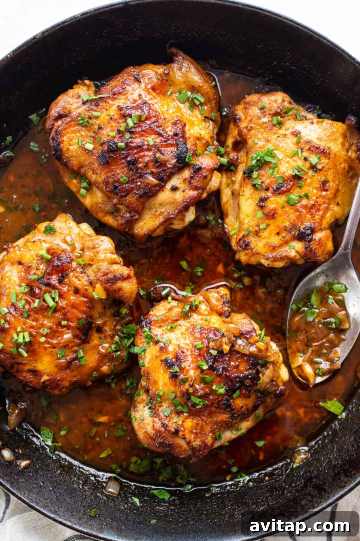 Perfectly Seared Cast Iron Chicken Thighs 6 A diverse spread of various cooked chicken thigh dishes prepared using different methods, showcasing versatility.