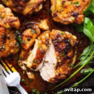 Perfectly Seared Cast Iron Chicken Thighs 9 Crispy Cast Iron Chicken Thighs, perfectly cooked and garnished with fresh herbs in a skillet.