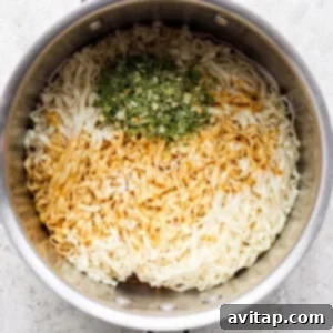a pan with rice and herbs in it.