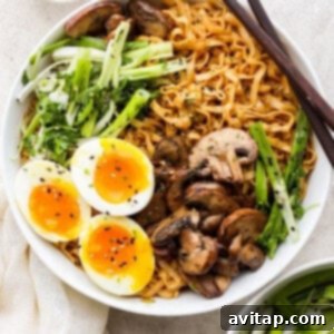 a bowl of asian noodles with an egg and mushrooms.