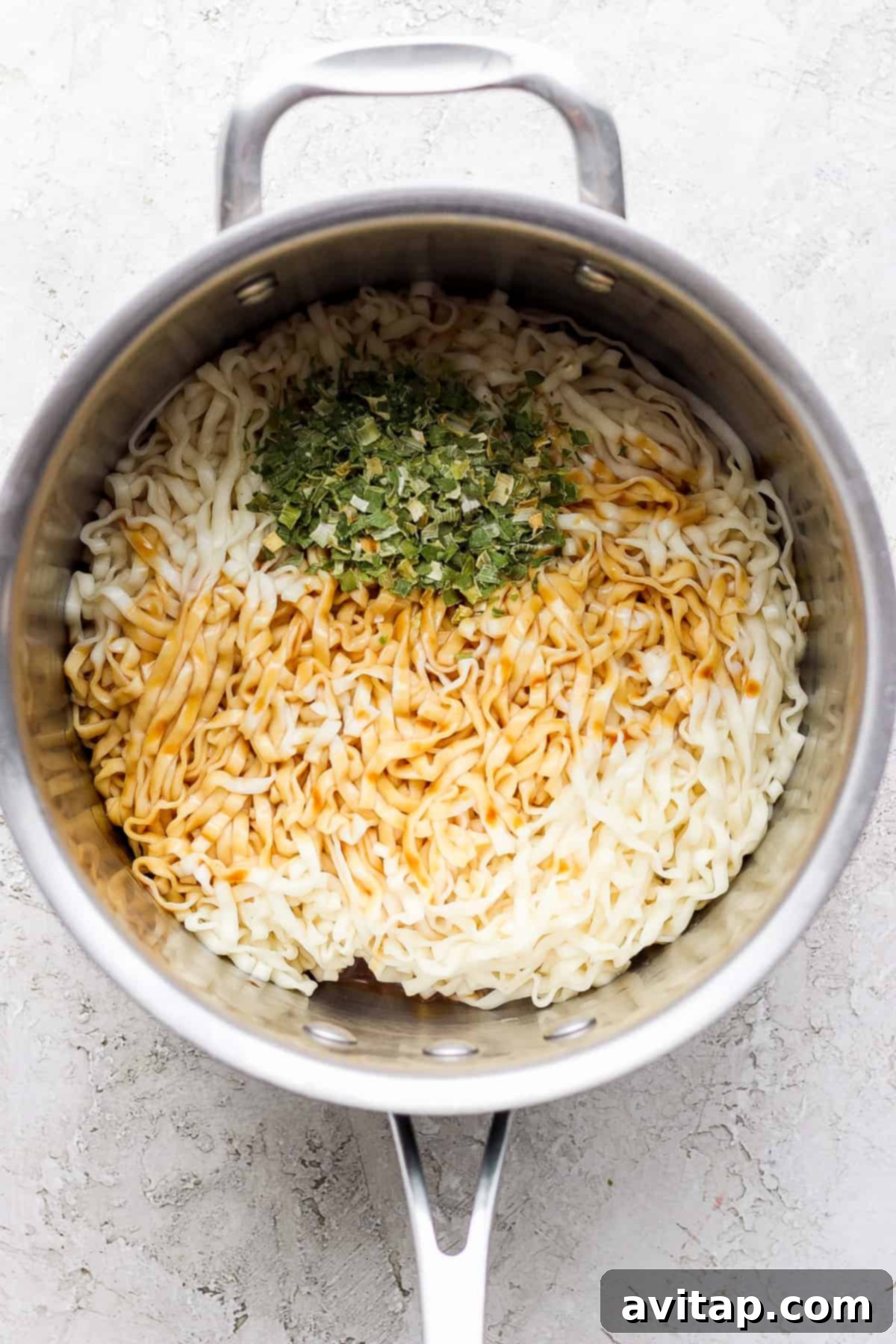 a pan with rice and herbs in it.