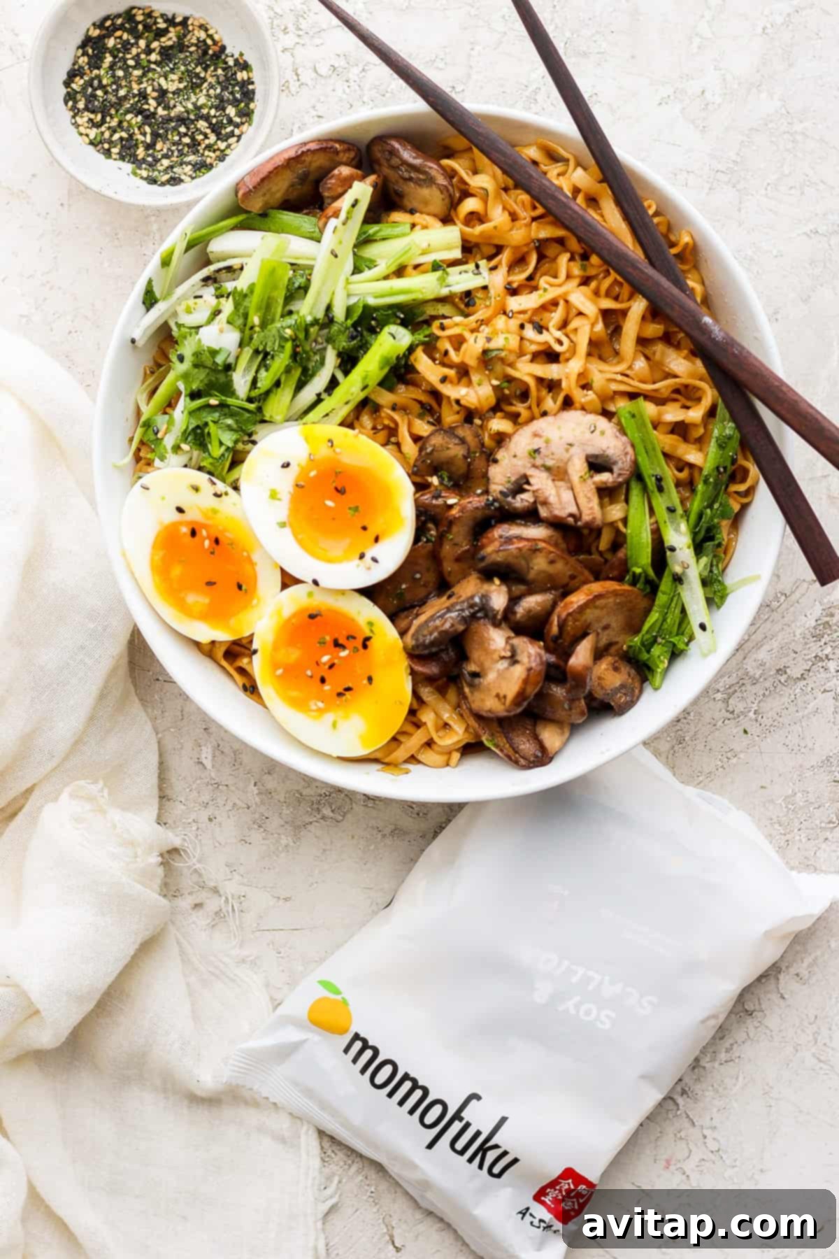 a bowl of ramen with mushrooms, eggs and chopsticks.