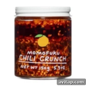 A jar of chili crunch on a white background.